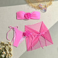 Women's pink tube top swimsuit with three-dimensional floral design and coordinating skirt