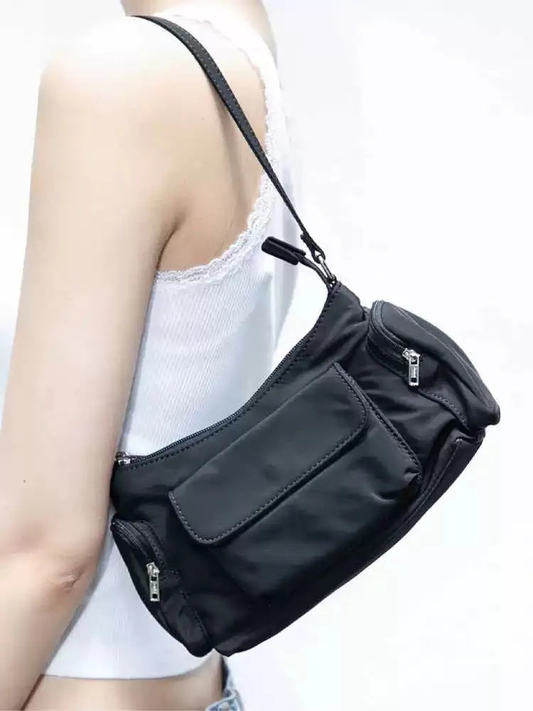 Simple black lightweight double pocket shoulder bag made of PU with side line detail.