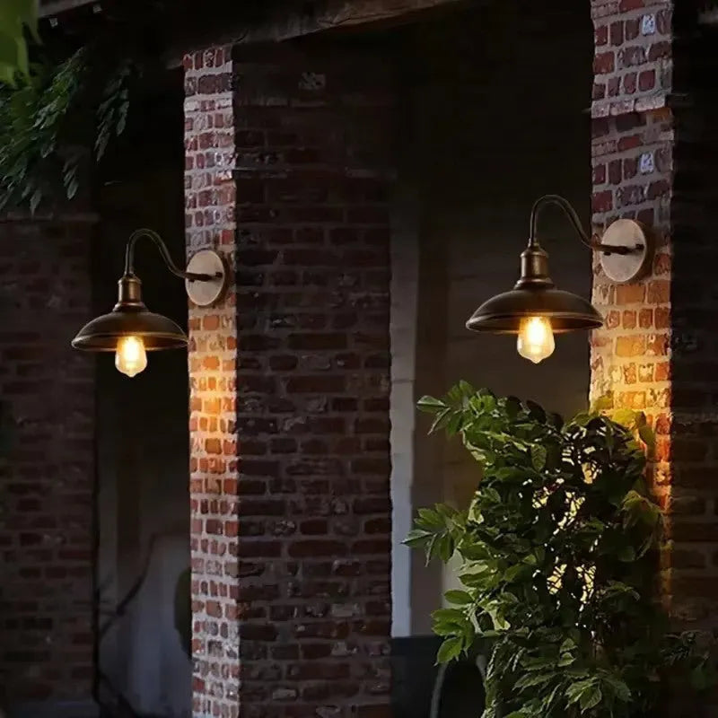 Retro-style outdoor wall lamp in a choice of silver or copper finish with angled arms.