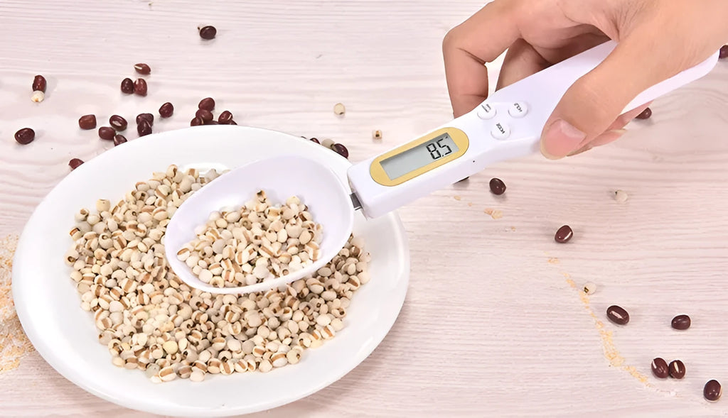 Black digital measuring spoon scale showing weight on display, with spoon bowl for holding materials.