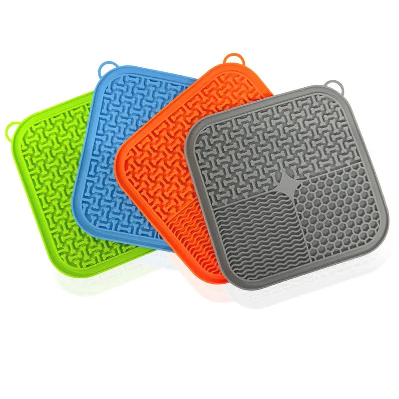 Blue silicone dog licking mat with textured surface and suction cups on back for slow feeding and anxiety relief