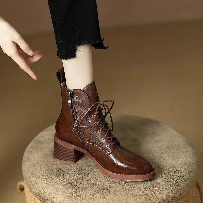 Women's black pointed-toe ankle boots with block heel and short shaft design