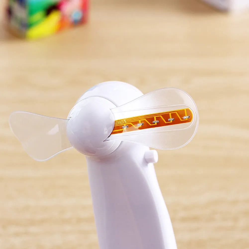 White handheld mini fan showing blue and red LED lights forming a heart and 'I love you' message.