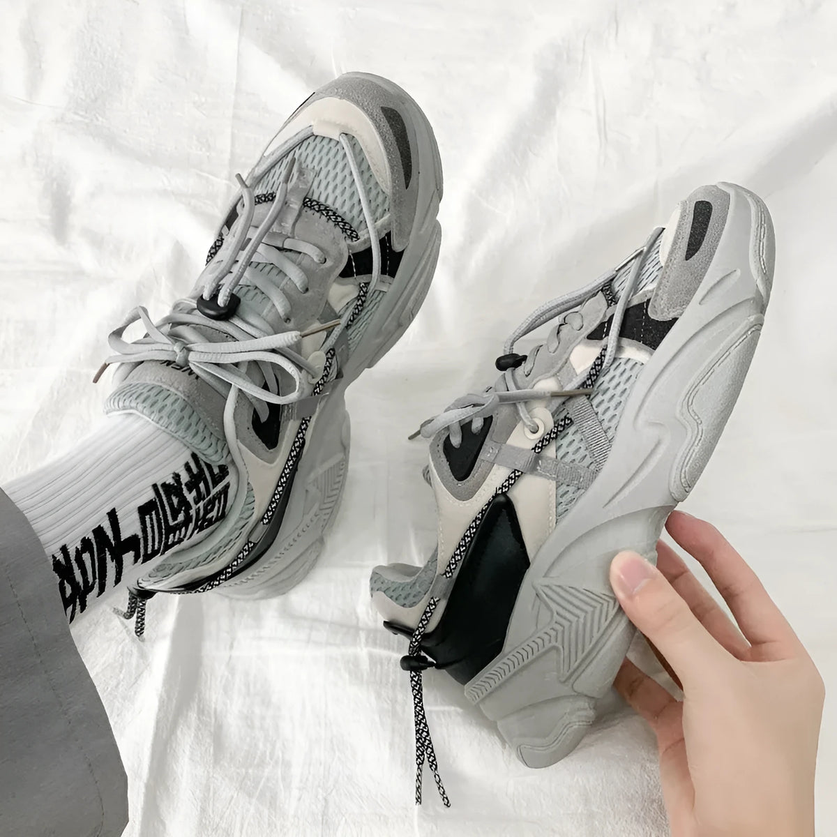 Men's white platform sneakers with lace-up front, shown on a neutral background.
