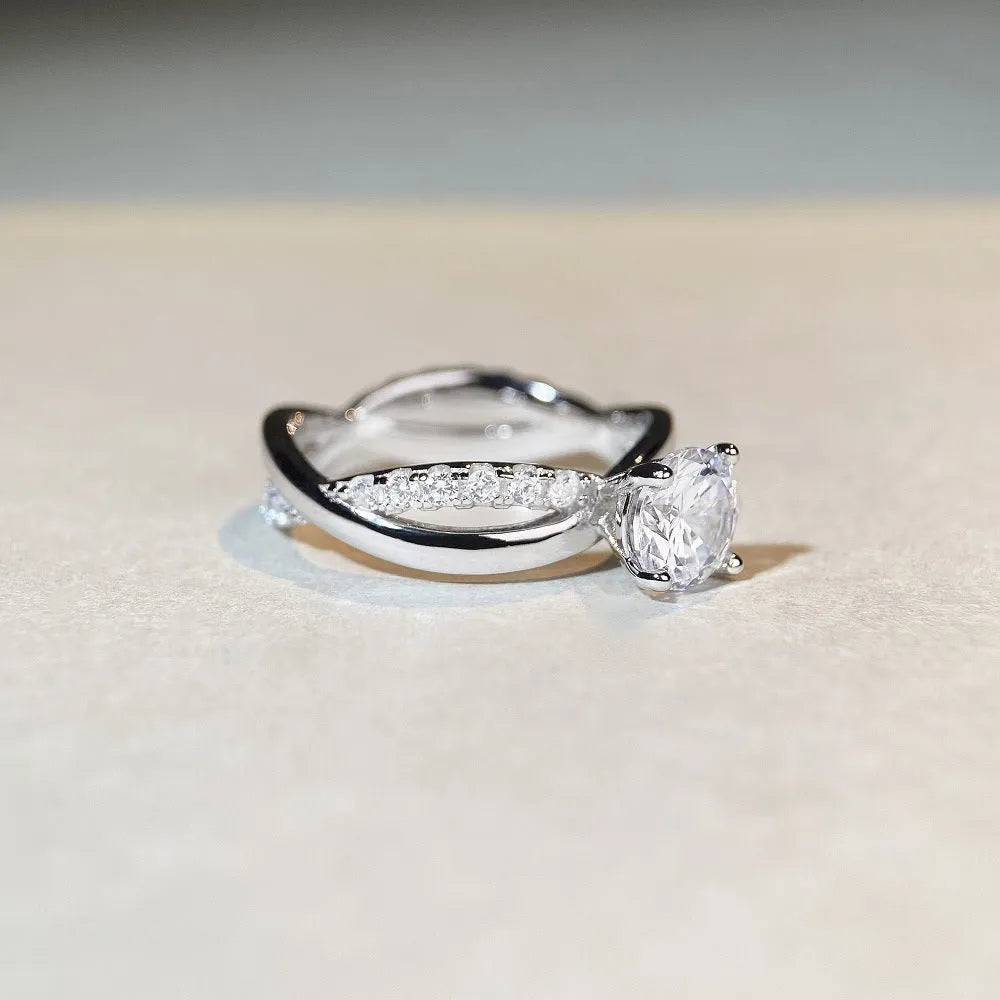 Silver ring with 1 karat moissanite stone in four-claw setting and twisted geometric arms