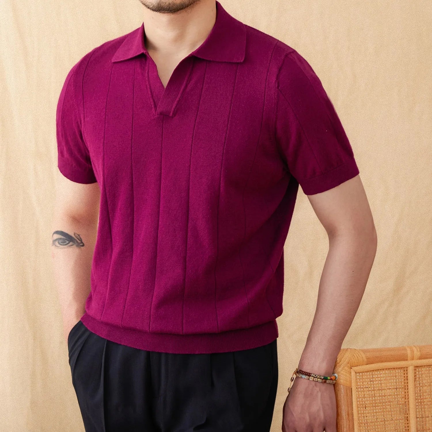 A purple short sleeve polo shirt with a seagull collar and a thin, sunken stripe knitted texture.