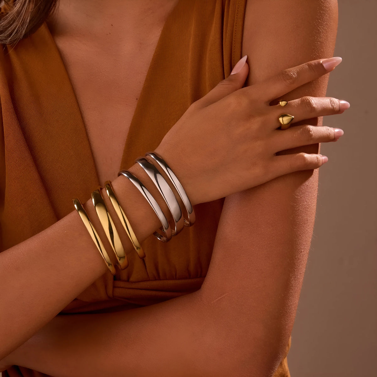 Geometric line stainless steel bracelet for women in gold tone or steel finish.