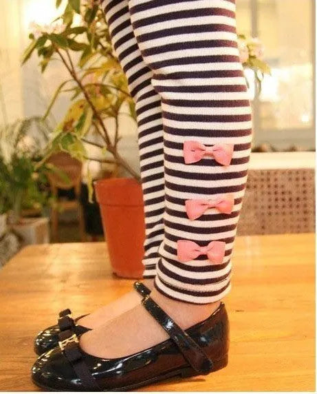 A pink cotton blend clothing set for a young girl, shown on a hanger.