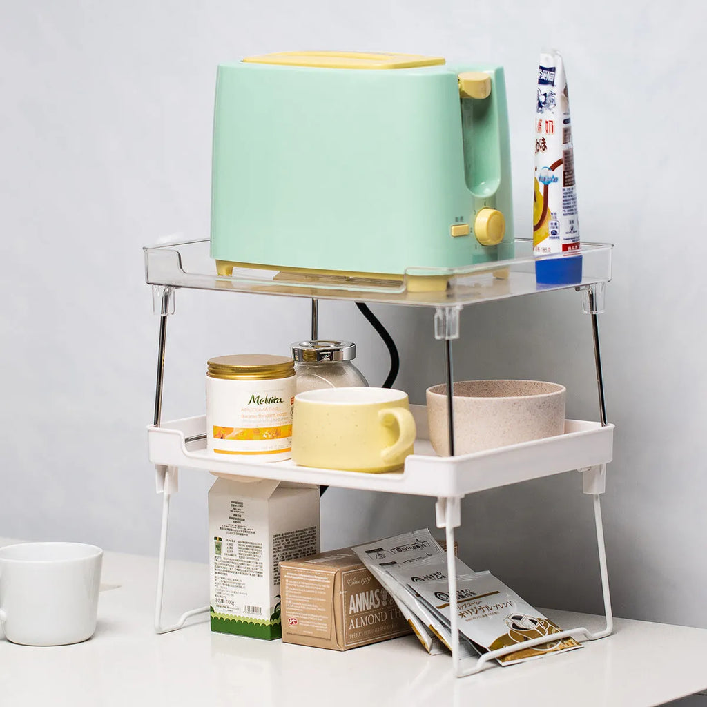 A transparent or white plastic kitchen supplies rack for organising utensils on a desktop or in a cupboard.