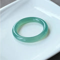 Natural agate wide tire bracelet shown in a pink agate colour variant on a wrist.