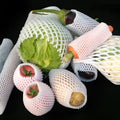 White foam net covers for fruit protection in multiple sizes on various fruits