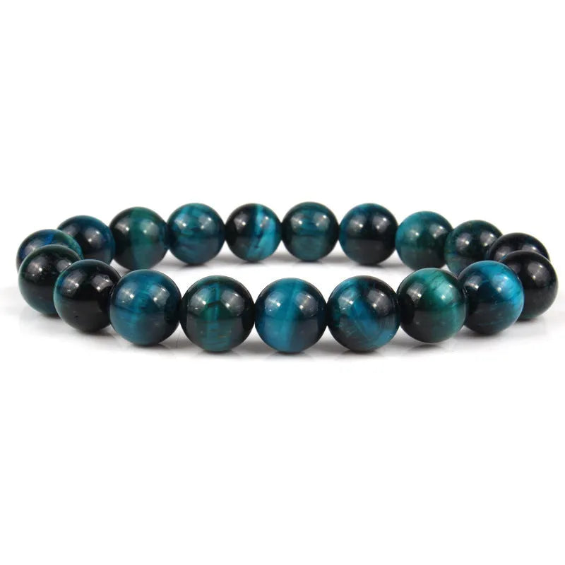 Natural tigereye crystal beaded bracelet with round beads, shown in a selection of colours and sizes on a wrist.