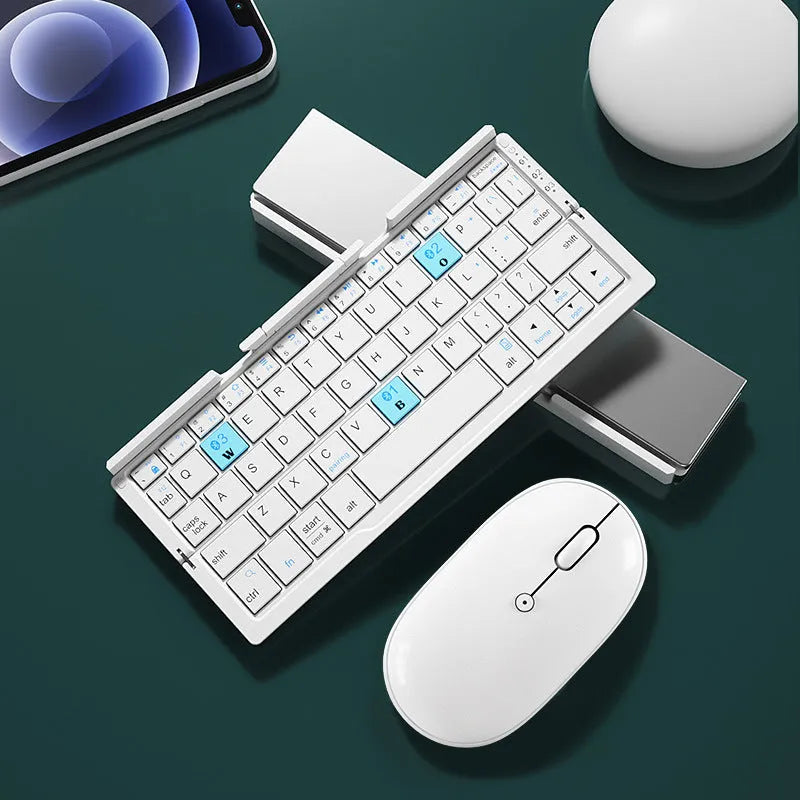 Silver folding Bluetooth keyboard open with tablet on stand, showing compact size and 60-key layout