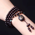 Zambia rosewood bead bracelet with flat lotus pendant showing 108 wooden beads