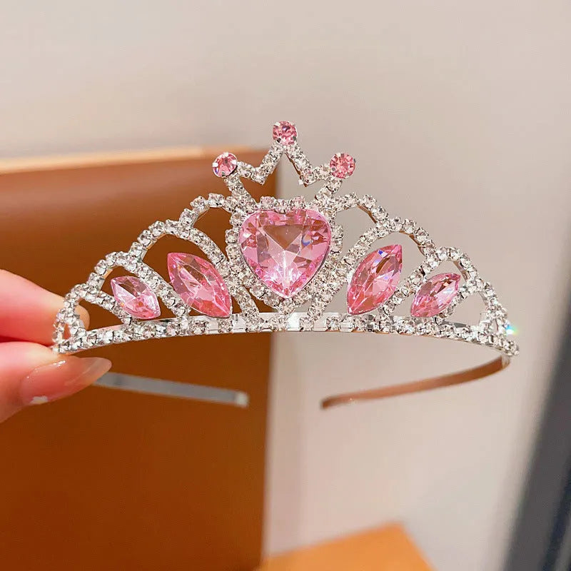 Close-up of a children's metal hairband headdress with a crown pattern in a light purple crystal colour.