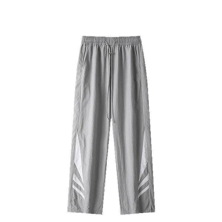 Men's straight-leg loose fit summer sports trousers in grey, showing button fly and elastic waistband.
