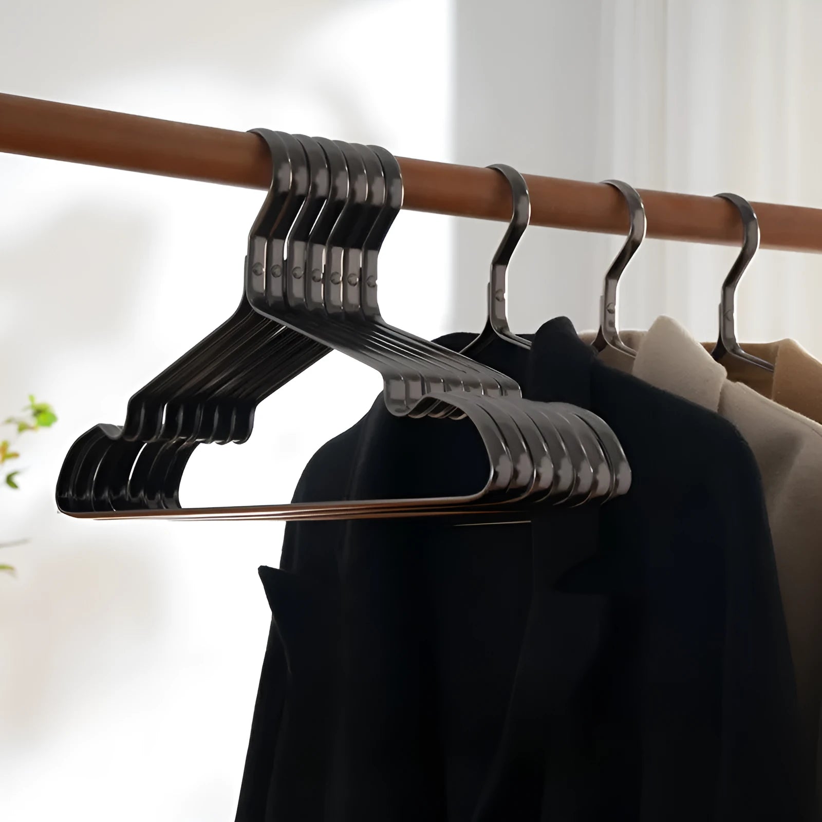 Black steel wire clothes hanger with non-slip coating for trousers and ties.