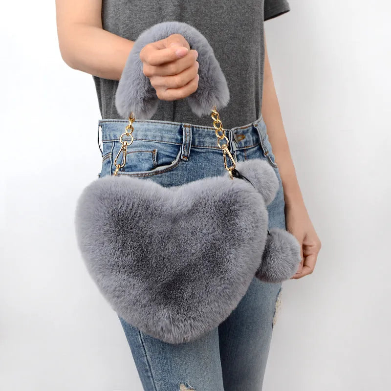 Medium soft plush heart handbag in solid color with zipper closure and shoulder strap option for women
