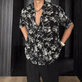 Men's loose-fit printed short sleeve shirt with pendant detail and floral pattern in white or black colours