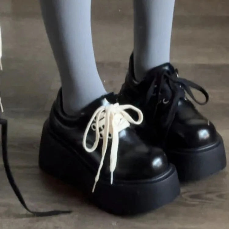 Women's matte black retro ankle boots with a thick rubber sole and buckle fastening on the side.