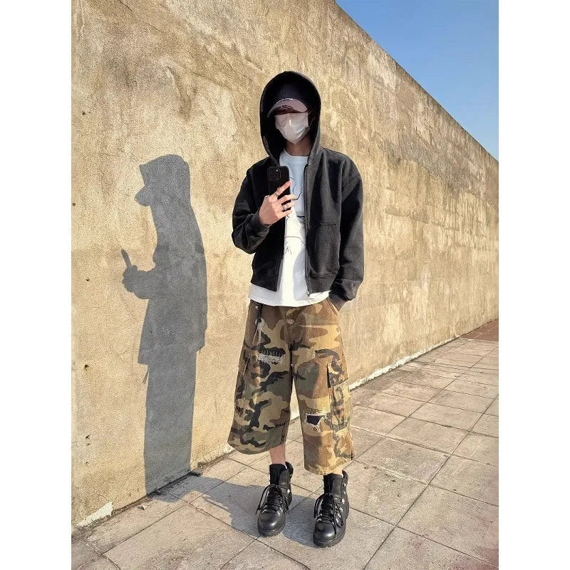 Men's camouflage coloured cropped jeans with ripped detailing and retro patch accents