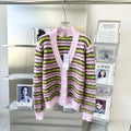 Pink wool lazy coat Haima cardigan sweater with nap craft texture on a hanger.