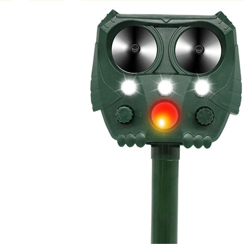 Green solar-powered ultrasonic animal repeller unit with solar panel on top
