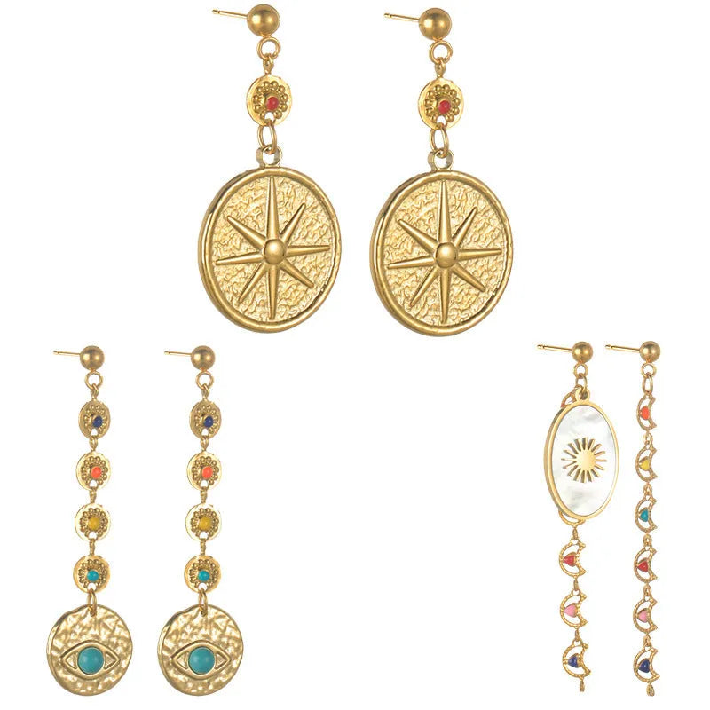 Geometric stainless steel drop earrings showing eight awn star, eye, and shell sun designs