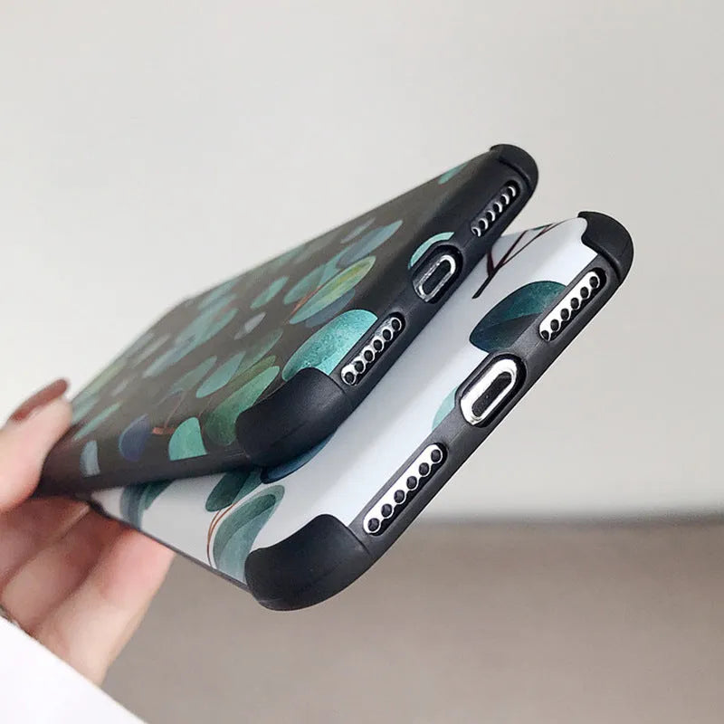 Black silicone phone case with a leaf design for various iPhone models.