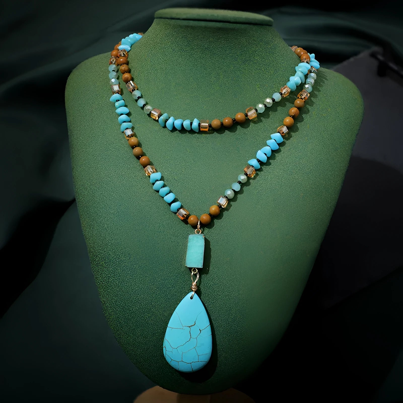 Long turquoise blue water drop pendant necklace with mixed gem inlay on a ball bead chain for women.
