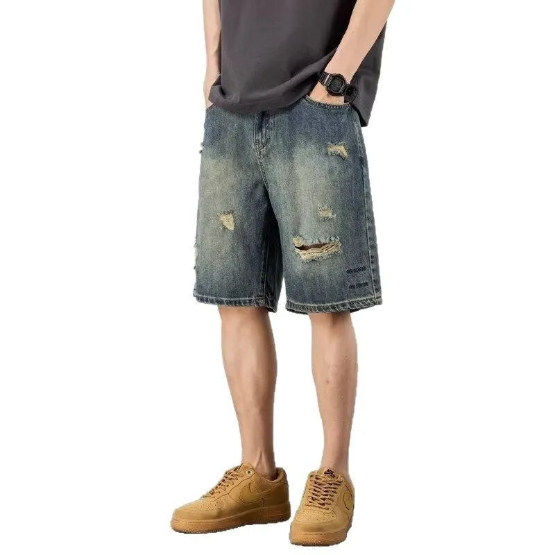 Blue retro loose hole men's denim shorts with a straight cut, shown on a model.