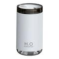 White jellyfish-shaped USB humidifier with warm night light on a wooden table.