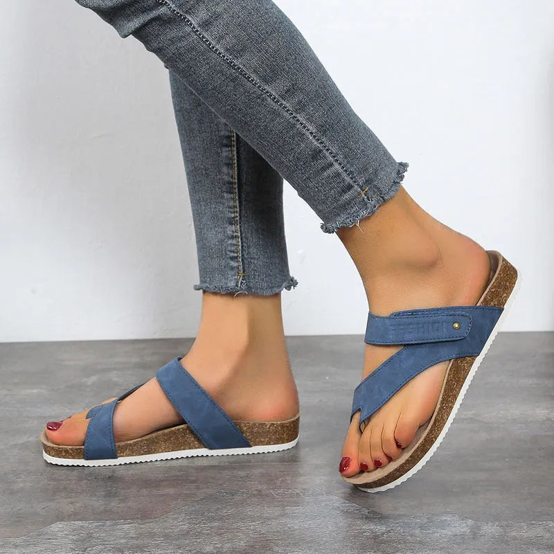 A pair of women's thick-soled flip-flops with a flat toe ring design in a solid colour.