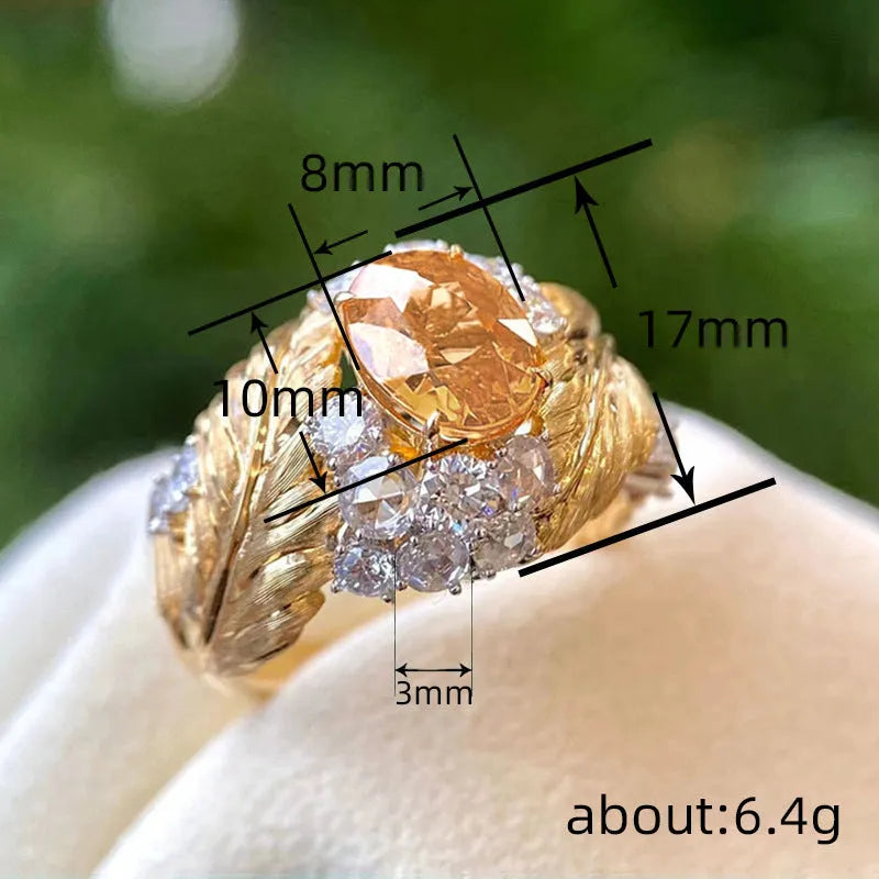 Gold-colour copper women's ring with embossed feather pattern and yellow zircon stone