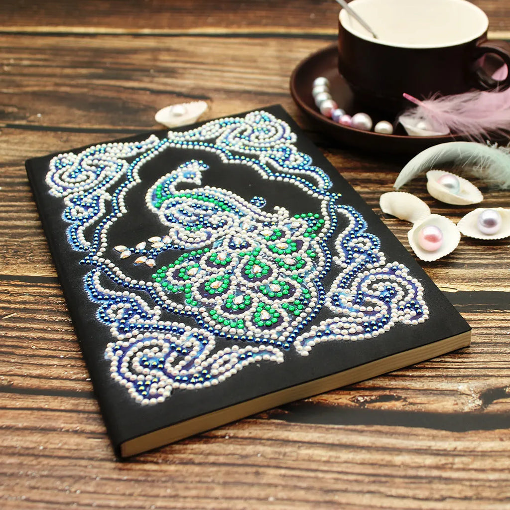 Black A5 diamond painting notebook with peacock design showing shaped and bright drill beads