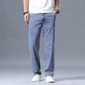 Men's loose straight-leg lyocell jeans in light blue, shown with a zipper fly.