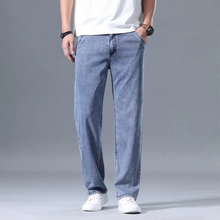 Men's loose straight-leg lyocell jeans in light blue, shown with a zipper fly.