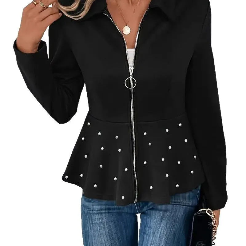 Women's loose black coat with heavy-duty zipper and ruffled hem, shown on a hanger