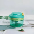 Green manual baby food grinder with stainless steel blades showing 10.8cm diameter and 9.2cm height