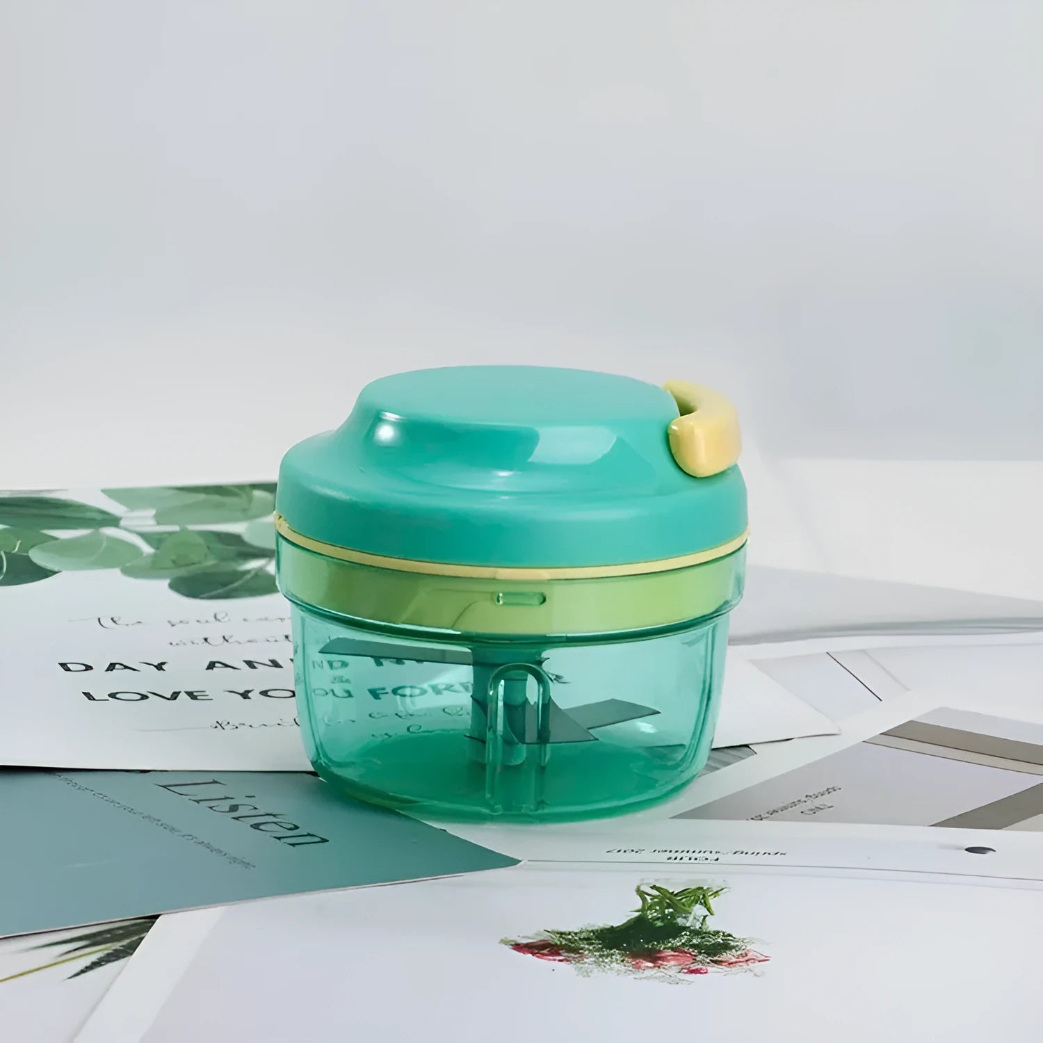 Green manual baby food grinder with stainless steel blades showing 10.8cm diameter and 9.2cm height