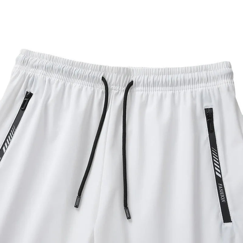 Men's black loose-fit nylon sports shorts with elastic waistband on a hanger