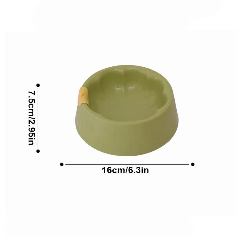 Green plastic pet bowl with dual compartments for food and water, anti-tipping design