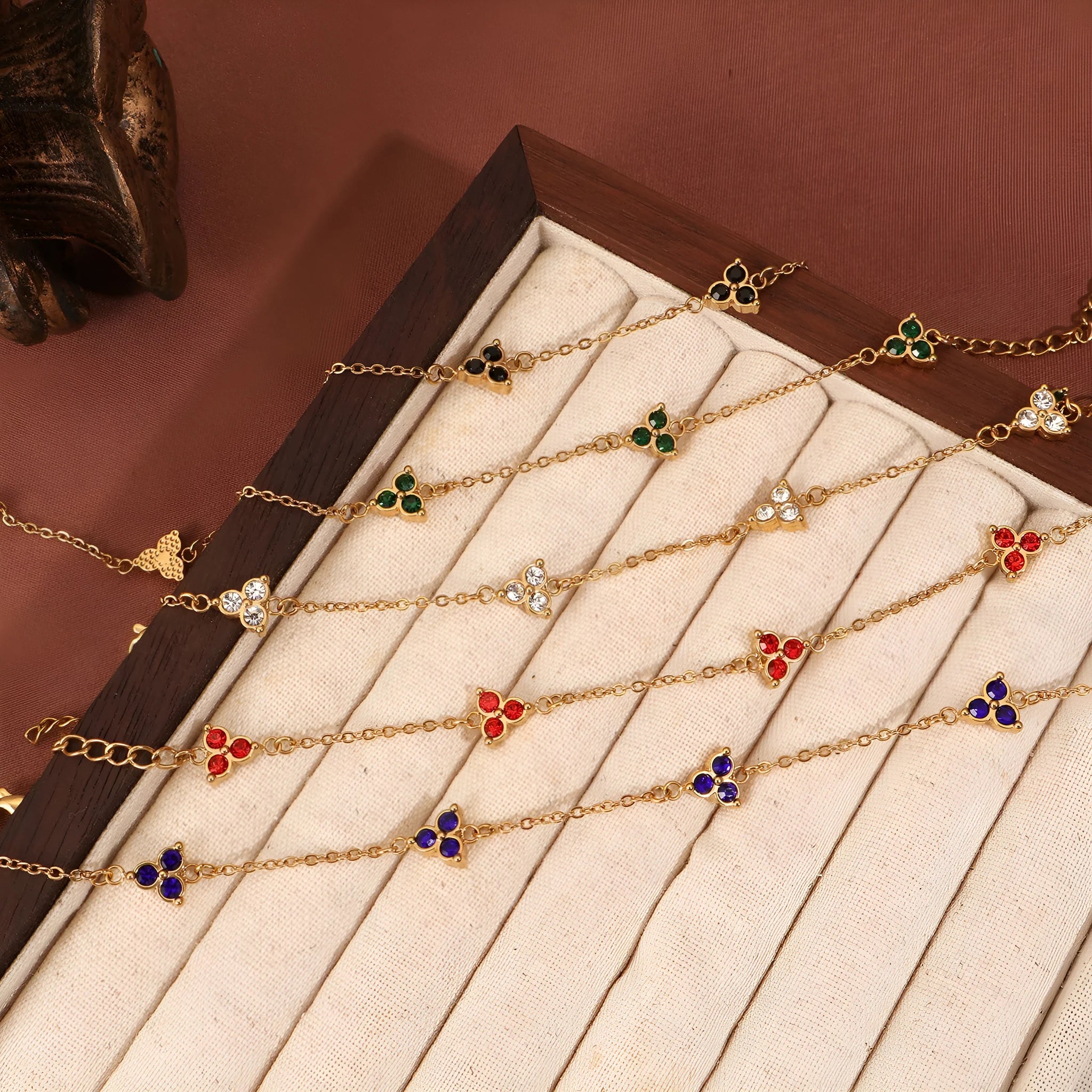 Geometric triangle bracelet for women in stainless steel with coloured zircon stones.