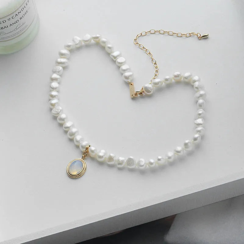 Geometric silver pendant pearl necklace with adjustable chain on white background