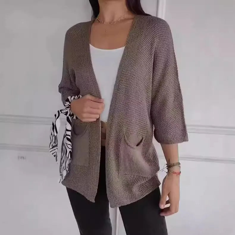 Women's army green waffle knit cardigan coat with nine-quarter sleeves and pockets.
