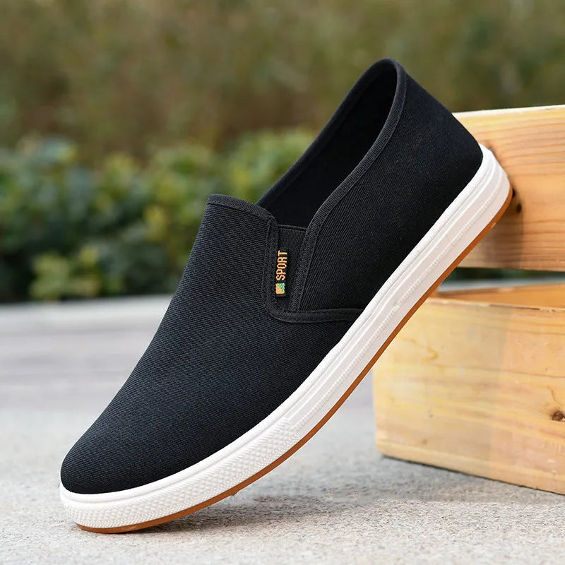 Men's black low-top canvas slip-on shoes with round toe and composite sole