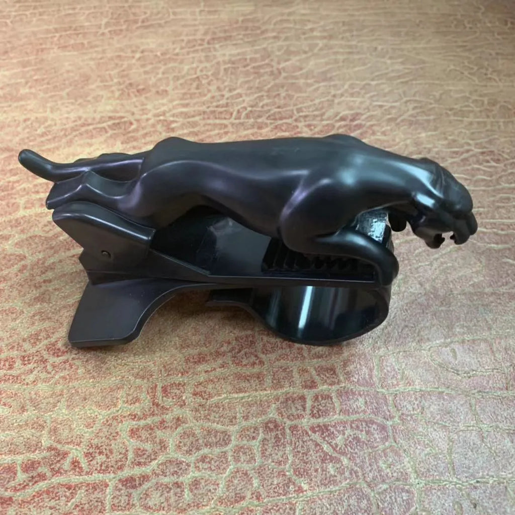 A black rotatable car mobile phone holder made of ABS plastic, mounted on a dashboard.