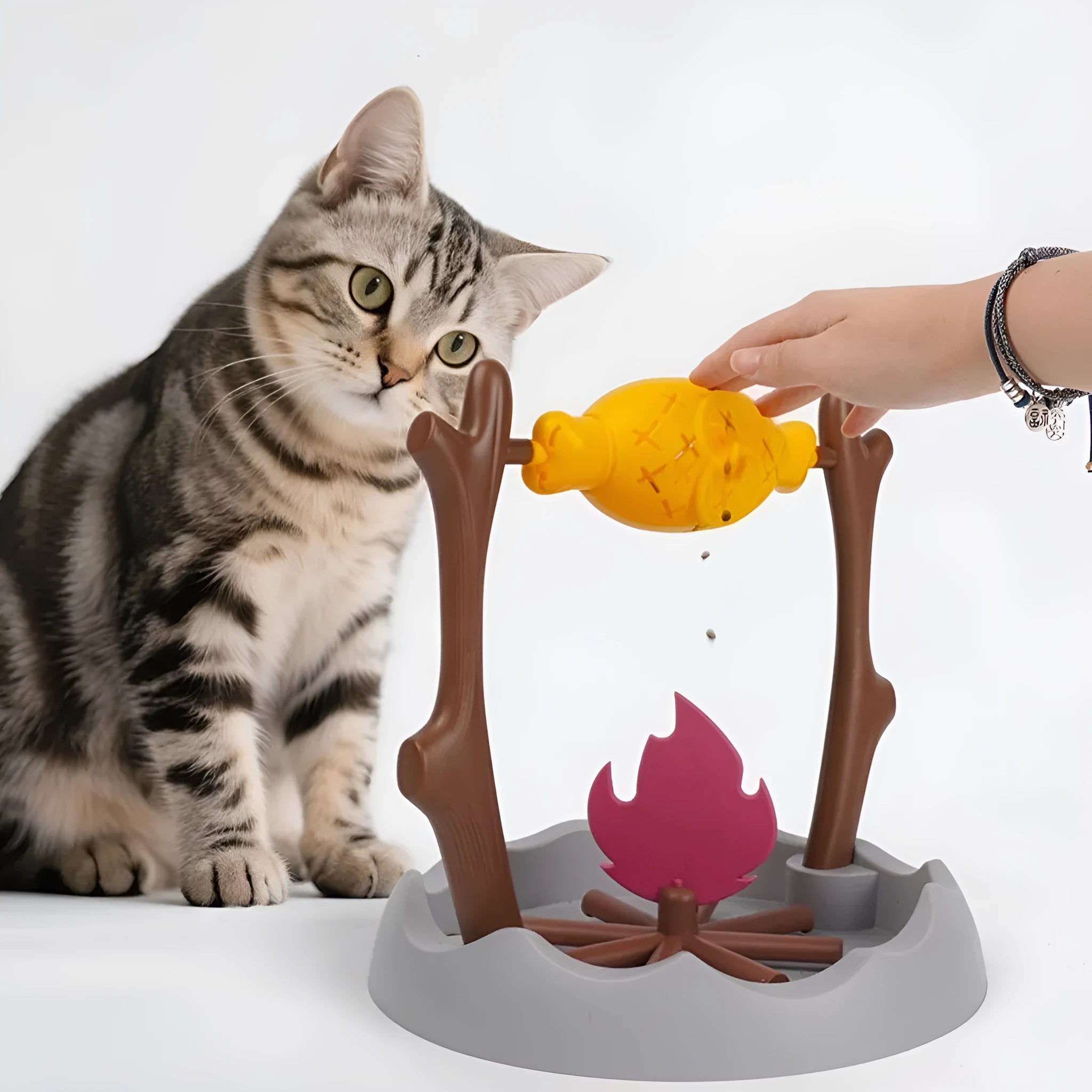 Barbecue-style plastic cat tumbling food feeder toy with multiple openings for treat dispensing