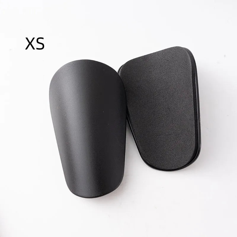 PU mini shin guards in various colours on a leg, showing S and XS sizing for sports protection.