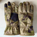 A pair of tactical winter ski gloves in camouflage colour with visible silicone grip pattern on the palm.